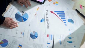 people analyzing business charts and graphs on a table - Powered by Shutterstock - Get 15% off with code: PIKWIZARD15