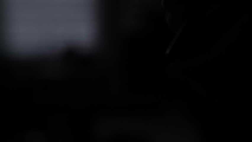 Close-Up of Hand Holding Lit Candle in Dark Atmosphere