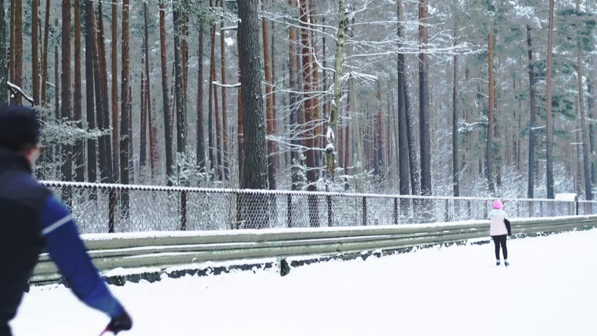 People skiing past on a forest track copy space