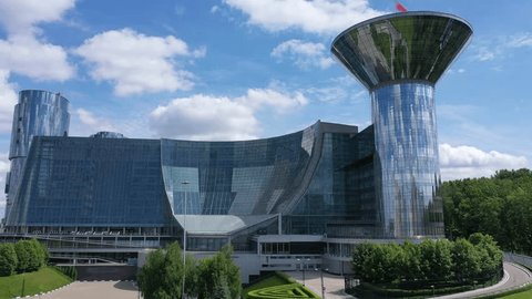 Drone Rotating While Descending near Modern Office