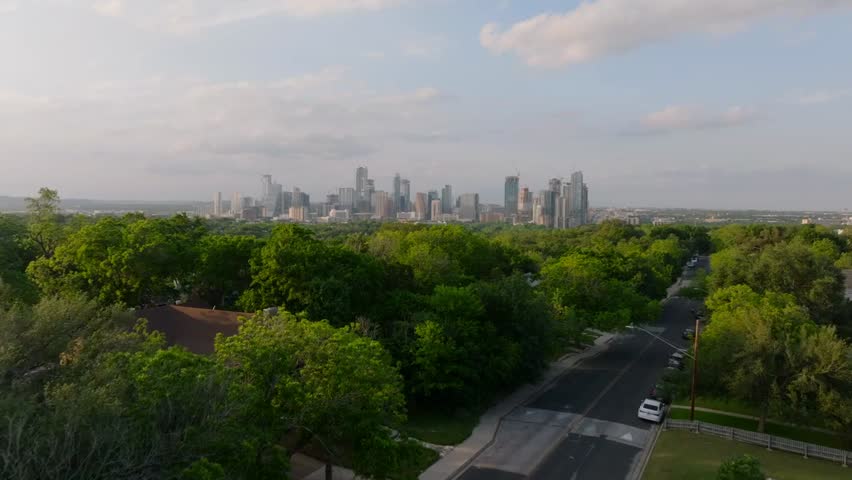 Aerial view of Austin, Texas blending modern urban infrastructure with natural landscapes, showcasing rapid city growth, green spaces, and lifestyle.