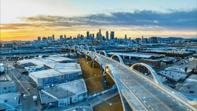 Hyperlapse of Los Angeles urban borough with a modern road bridge over a river at sunset, overlaid with digital lines and charts analyzing collected data. - Powered by Shutterstock - Get 15% off with code: PIKWIZARD15