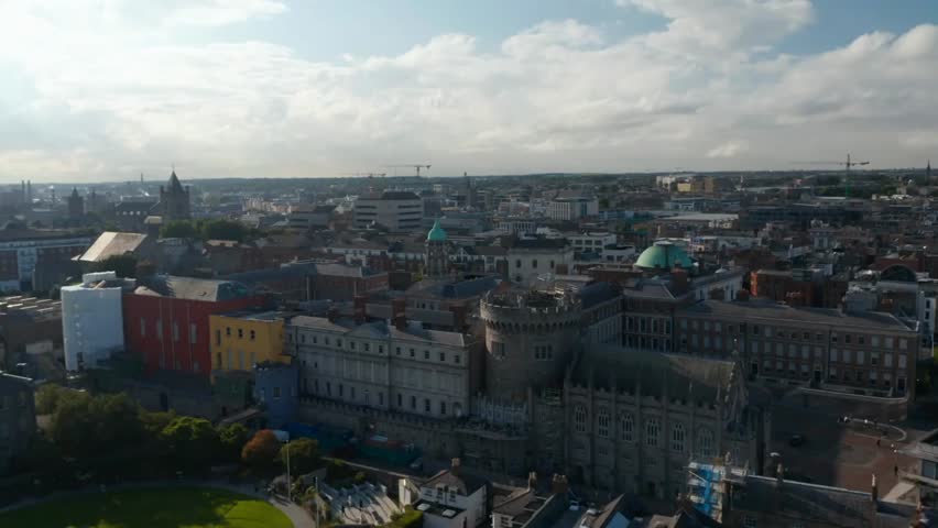 Slide and pan aerial view of Dublin Castle complex, showcasing historic buildings and architecture in the heart of Dublin, Ireland.