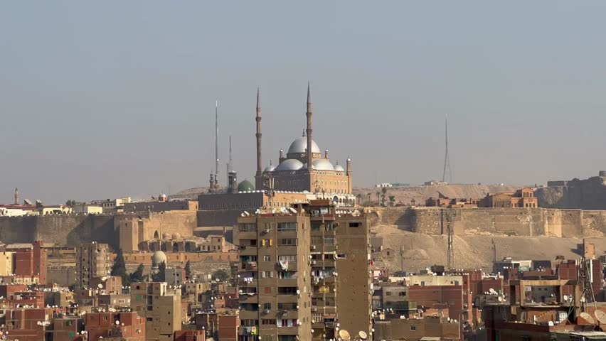 Aerial view of Old Cairo with the Citadel and Alabaster Mosque on a hilltop, highlighting historic Egyptian heritage sites and iconic cityscape.