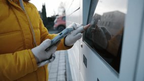 Girl Entering Code To Outdoor Automated Parcel Locker To Pick Up The Parcel - Powered by Shutterstock - Get 15% off with code: PIKWIZARD15