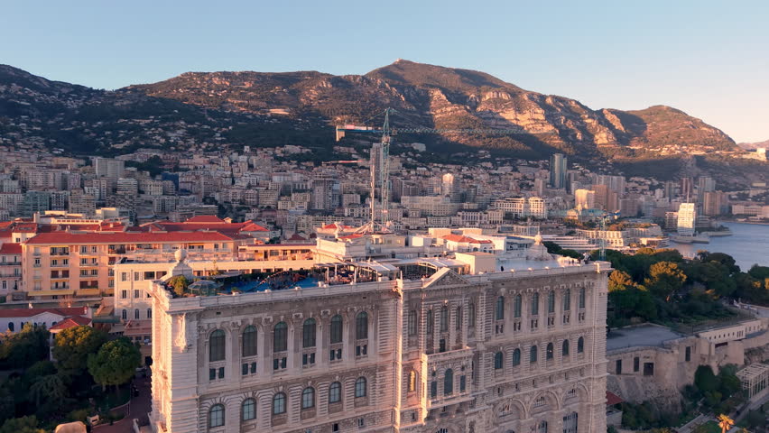 Aerial Cityscape Golden Hour Over Facades, Hillside Skyline And Coastal Bay Drone Sweeps Across Ornate Palace. Monaco