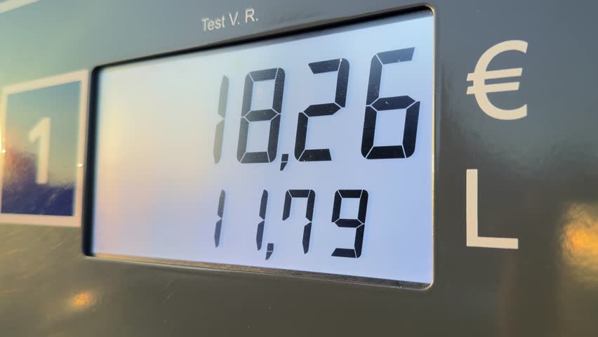 Close-up video of a gasoline pump during refueling, showing the digital display as liters and euros increase in real time. The footage highlights everyday fuel consumption, transportation costs, and modern service station technology, focusing on numbers, motion, and the refueling process.