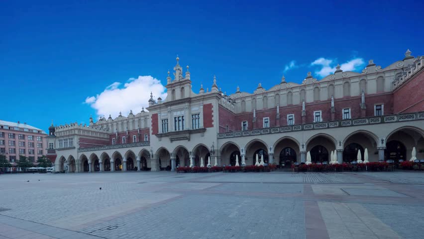view of sunshine architecture of ancient market building in KrakowKrakow, Poland - June 11 2018: Krakows Grand Market Square: Adam Mickiewicz Monument and Cloth Hall on Bright Summer Day, a Historical and Cultural Landmarkcapital cities, style, wind, exterior, house, public, dove, national, illumination, built, home, religion, fly, god, historical, empty, old city, main, morning, main square, vacation, rynek glówny, wawel, evening, royal, landscape, incidental people, city life, royalty, famous place, building exterior, unesco world heritage site, town square, palace, travel destinations, built structure, community, cultures, color image, fame, photography, unity stall, people, capital cities, tradition, outdoors, castle, beautiful, medieval, cathedral, street, tourist, tower, cityscape, basilica, monument, ancient, historic building, old town, gothic, famous, church, square, pigeon, view, europe, cloth hall, krakow, history, poland, travel, polish, culture, urban, market, old, historic, architecture, day, landmark, cracow, building, renaissance, tourism, hall, facade, city, horizontal, main, tourists, outside, european
