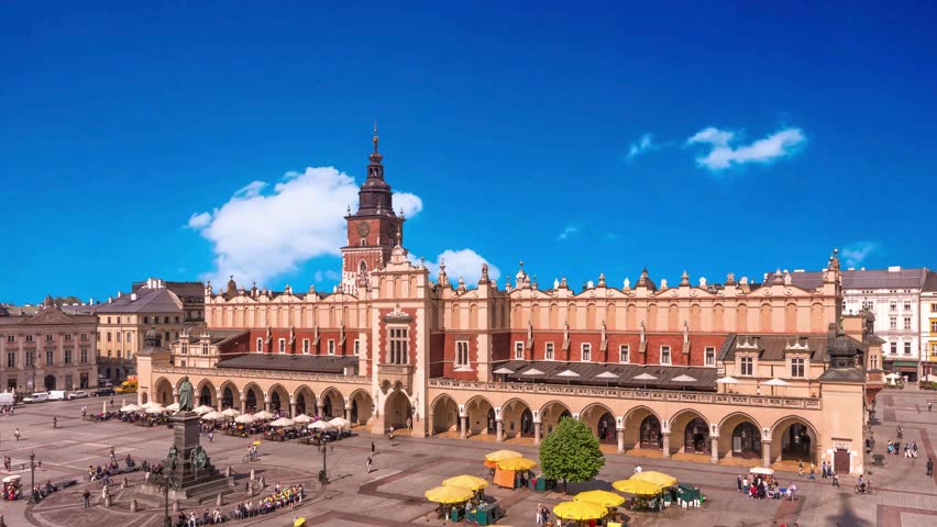 view of sunshine architecture of ancient market building in KrakowKrakow, Poland - June 11 2018: Krakows Grand Market Square: Adam Mickiewicz Monument and Cloth Hall on Bright Summer Day, a Historical and Cultural Landmarkcapital cities, style, wind, exterior, house, public, dove, national, illumination, built, home, religion, fly, god, historical, empty, old city, main, morning, main square, vacation, rynek glówny, wawel, evening, royal, landscape, incidental people, city life, royalty, famous place, building exterior, unesco world heritage site, town square, palace, travel destinations, built structure, community, cultures, color image, fame, photography, unity stall, people, capital cities, tradition, outdoors, castle, beautiful, medieval, cathedral, street, tourist, tower, cityscape, basilica, monument, ancient, historic building, old town, gothic, famous, church, square, pigeon, view, europe, cloth hall, krakow, history, poland, travel, polish, culture, urban, market, old, historic, architecture, day, landmark, cracow, building, renaissance, tourism, hall, facade, city, horizontal, main, tourists, outside, european