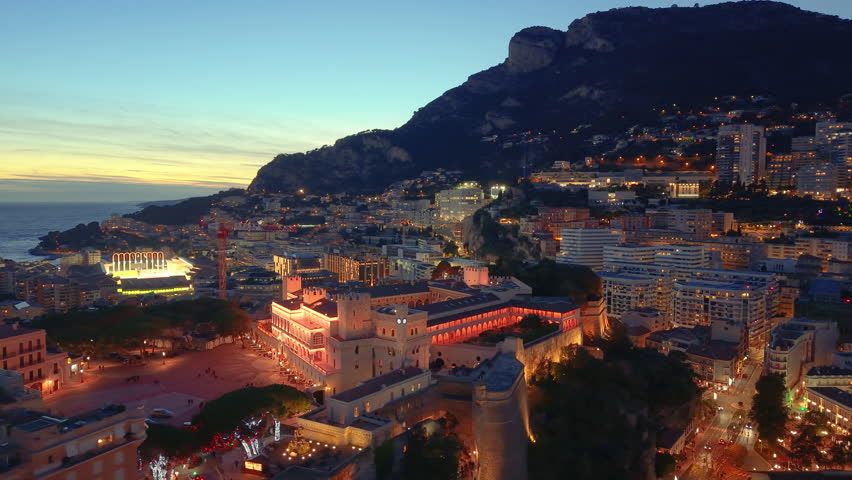 Aerial Cityscape Golden Hour Over Facades, Hillside Skyline And Coastal Bay Drone Sweeps Across Ornate Palace. Monaco