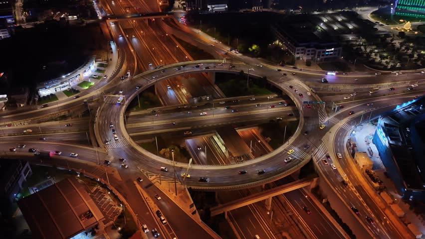Aerial drone night cinematic video of illuminated multilevel ring road junction crossing Attiki Odos and National motorway in Northern Athens, Attica, Greece	