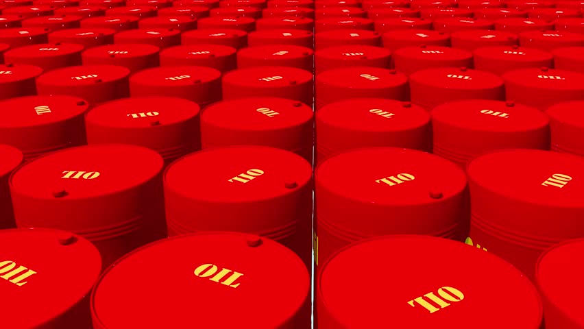 Group of red oil barrels near wastewater treatment area, showing signs of corrosion and usage. Industrial storage of hazardous materials.