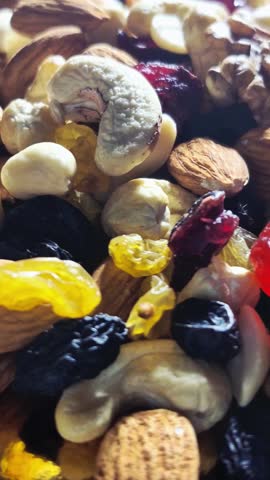 Healthy organic trail mix background with almonds, walnuts and raisins.