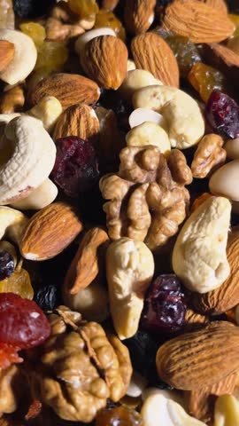 Healthy organic trail mix background with almonds, walnuts and raisins.