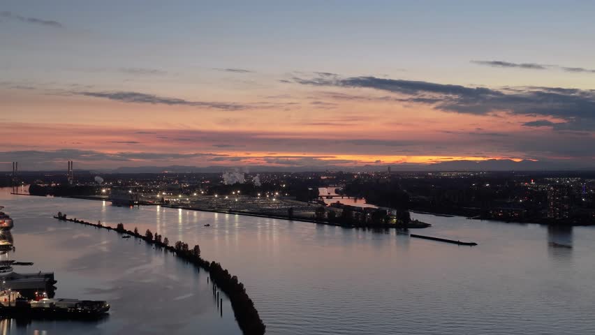 Aerial Sunset View Over New Westminster, British Columbia, Illuminating the Fraser River and Industrial Cityscape