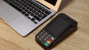 Customer is seen using their mobile phone to securely make a contactless payment on a pos terminal. This transaction is a simple and contemporary nfc wireless payment method - Powered by Shutterstock - Get 15% off with code: PIKWIZARD15