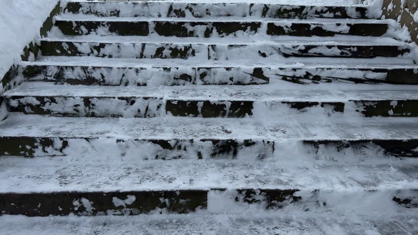 Close-up of slippery steps covered with ice-crusted, Staircase covered with a layer of ice