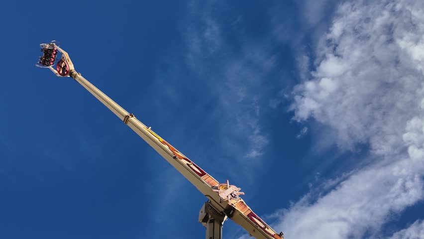 Cannstatter Wasen Volksfest or Octoberfest, beer festival and traveling funfair in Stuttgart, Germany, Oktoberfest 2023. With a high up seesaw