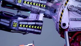 Detailed view of colorful LED lights and mechanical arms rotating against a twilight sky. - Powered by Shutterstock - Get 15% off with code: PIKWIZARD15