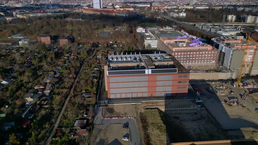 datacenter building with quantum computer science and technology park in Berlin City with modern buildings, urban skyline. Fantastic aerial view descending drone