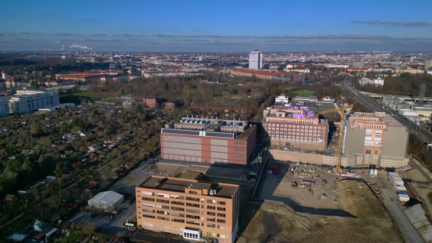 datacenter building with quantum computer science and technology park in Berlin City with modern buildings, urban skyline. Stunning aerial view fly push forward drone