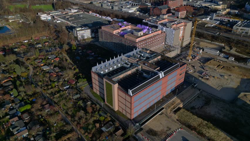 datacenter building with quantum computer science and technology park in Berlin City with modern buildings, urban skyline. Fabulous aerial view drone camera pointing down