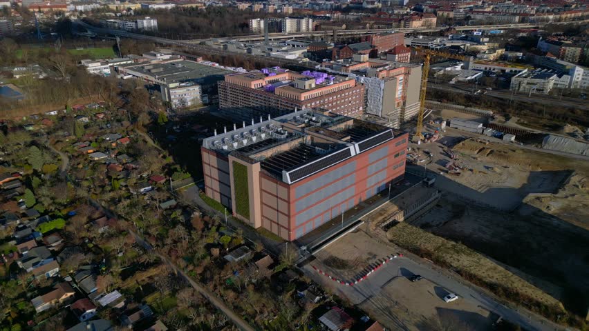 datacenter building with quantum computer science and technology park in Berlin City with modern buildings, urban skyline. Majestic aerial view wide orbit overview drone