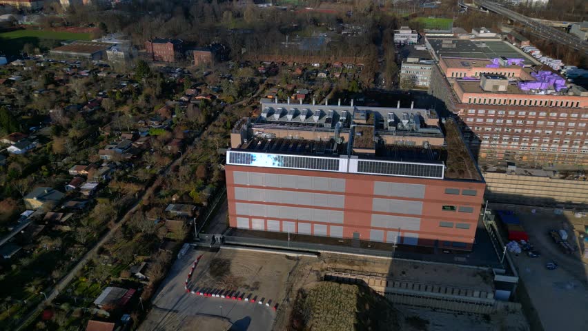 datacenter building with quantum computer science and technology park in Berlin City with modern buildings, urban skyline. Dramatic aerial view fly reverse drone