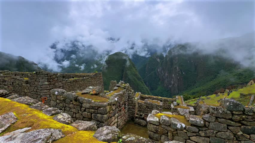 Machu Picchu circuit landscape view sunny cloudy morning Peru Perú aerial drone rainy season lush green jungle Peruvian Andes historic Inca Temple Sanctuary panoramic stone terrace layers follow