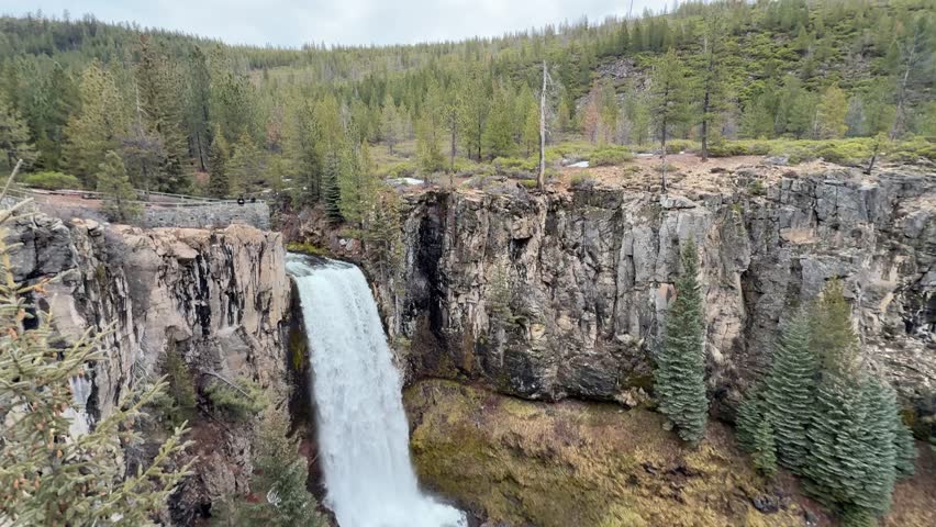 Wide view of Tumalo Falls in Oregon, featuring cascading water with lush forest and rugged Pacific Northwest landscape nature, travel, outdoor
