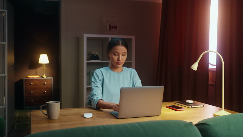 Asian woman worker remote hard work laptop home. Korean girl type keyboard. Female employee surfing net. Busy serious ceo person use pc. Online education. Computer freelance. Distant searching job.