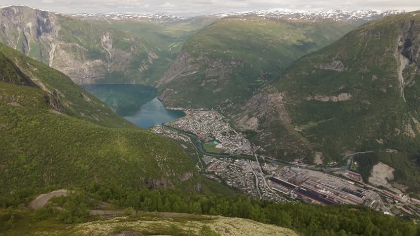 The Town of Øvre Årdal Sits Nestled Between Steep Green Mountains and a Deep Blue Fjord in Norway - Aerial Drone Shot