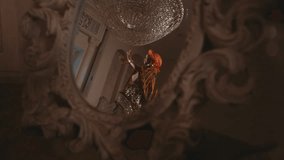 Pretty african female dancer dancing in royal palace, view in mirror, dance show . Beautiful black woman in ethnic african gown performing traditional ritual dance in luxury interior, seductive dance - Powered by Shutterstock - Get 15% off with code: PIKWIZARD15