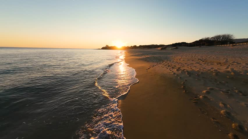 Ammolofoi Beach in Nea Peramos Kavala Greece, Beautiful Sunset Waves on Golden Sand, Fast Low-Altitude FPV drone footage