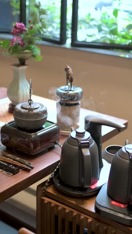 A captivating scene showcasing modern teapots and kettles on a stylish countertop, creating an inviting space for brewing delicious tea amid natural light and greenery.