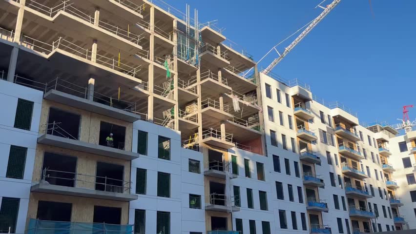 Tower cranes operating on a building construction site