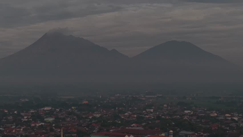 Aerial footage of foggy mountains looks very majestic close to each other