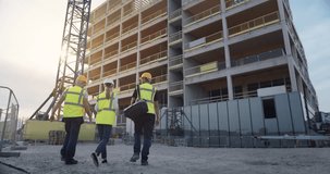 Construction Engineers Walk to a High Rise While Augmented Reality Light Lines Graphics Build the Structure, Projecting Digital Building Data, Smart Architecture, Modern Construction Digitalization - Powered by Shutterstock - Get 15% off with code: PIKWIZARD15
