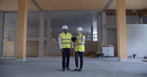 Two Engineers Use Digital Tablet Walk Through a Building Under Construction. Augmented Reality Overlays Show Hvac, Duct, and Piping Networks. 3D Digital Visuals and Smart Construction Visualization - Powered by Shutterstock - Get 15% off with code: PIKWIZARD15