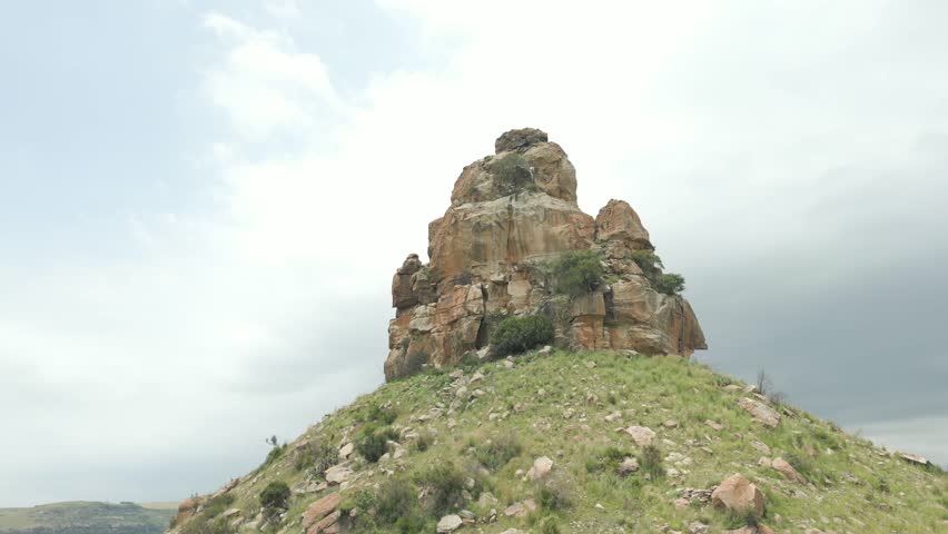 Fly around top of Qiloane Hill, looking up at the intricate sandstone formation