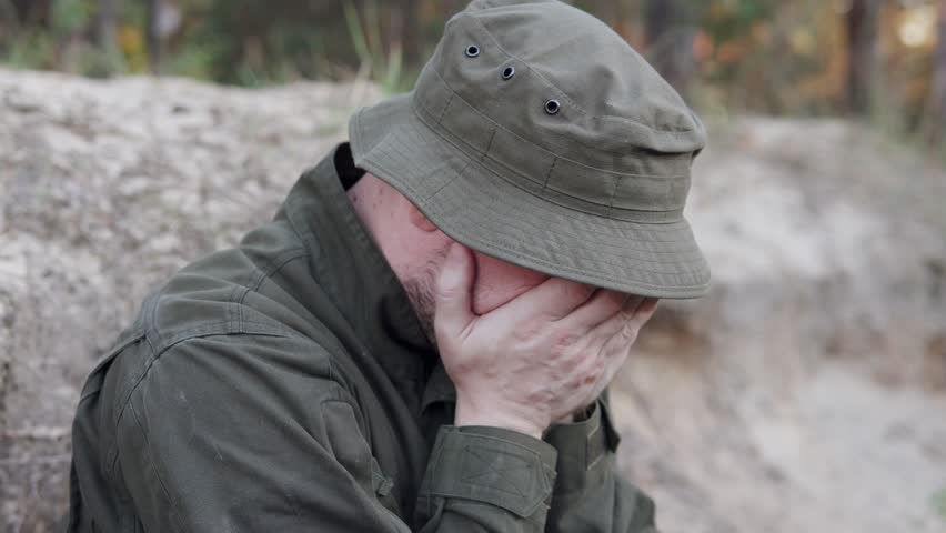 Military trainee experiences a panic attack while positioned in a foxhole during war drills.