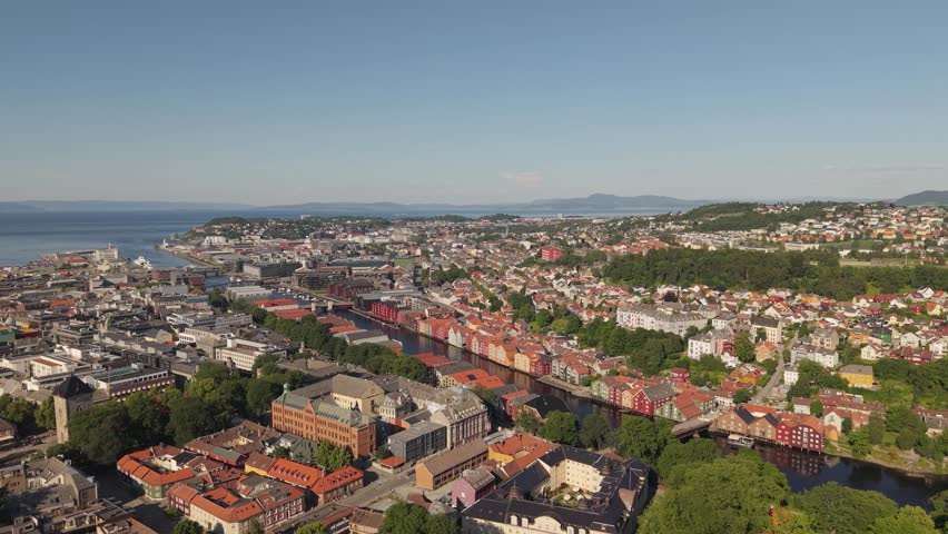 Trondheim, Norway - Colorful Riverside Buildings Line Winding Waterways as the City Stretches Toward the Coast - Aerial Drone Shot