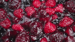 Fruits simmering in syrup, Vibrant red and burgundy berries cooking in sticky liquid, Closeup of simmering raspberries and dark fruits in shiny syrup with seed details - Powered by Shutterstock - Get 15% off with code: PIKWIZARD15
