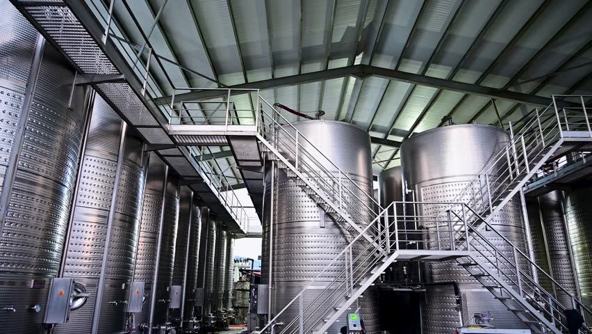 Large stainless steel wine fermentation tanks inside a modern production facility in Kvareli, Georgia in the Kakheti region.