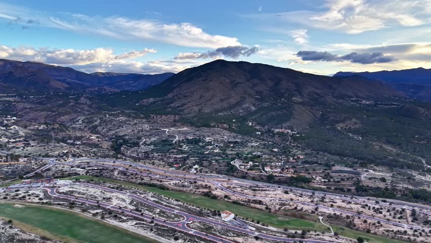 aerial foothill town with mountain, sweeping view across residential neighborhoods, highways and river, soft