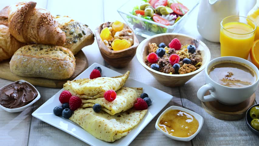 Breakfast served with coffee, orange juice, croissants, cereals and egg. Balanced diet.