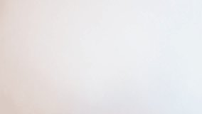 Heart shaped paper confetti falling on white paper background. St. Valentines Day romantic surprise, wedding decor, flying hearts, falling in love concept. Closeup slow motion video. - Powered by Shutterstock - Get 15% off with code: PIKWIZARD15