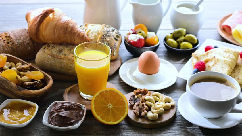Breakfast served with coffee, orange juice, croissants, cereals and egg. Balanced diet.