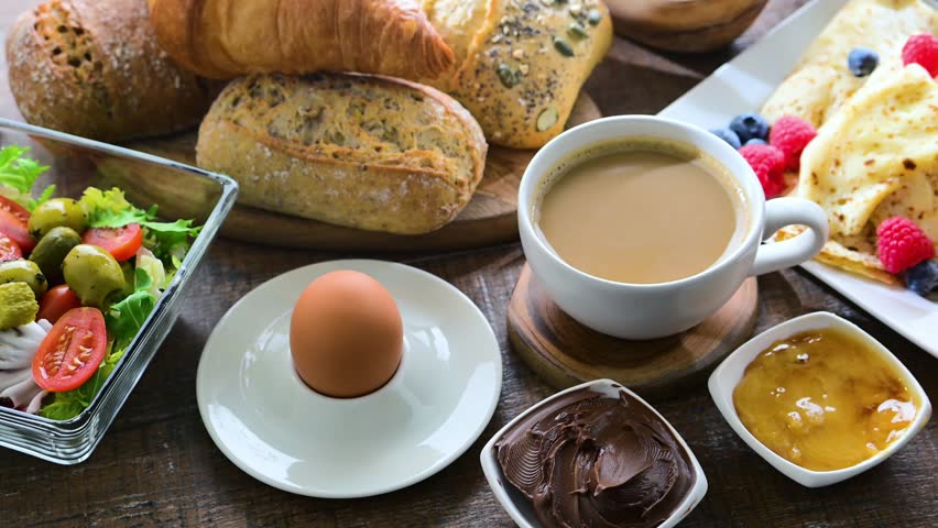 Breakfast served with coffee, orange juice, croissants, cereals and egg. Balanced diet.