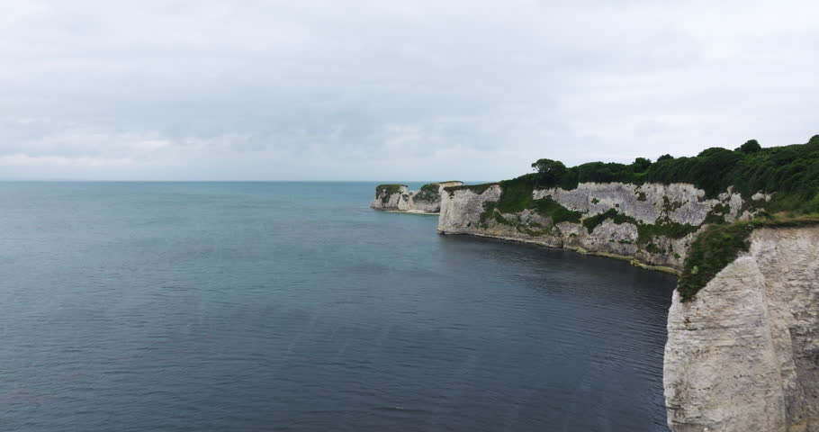 Calm Waters Of English Channel With Chalk Cliffs And Old Harry Rocks In Dorset, England. - aerial shot
